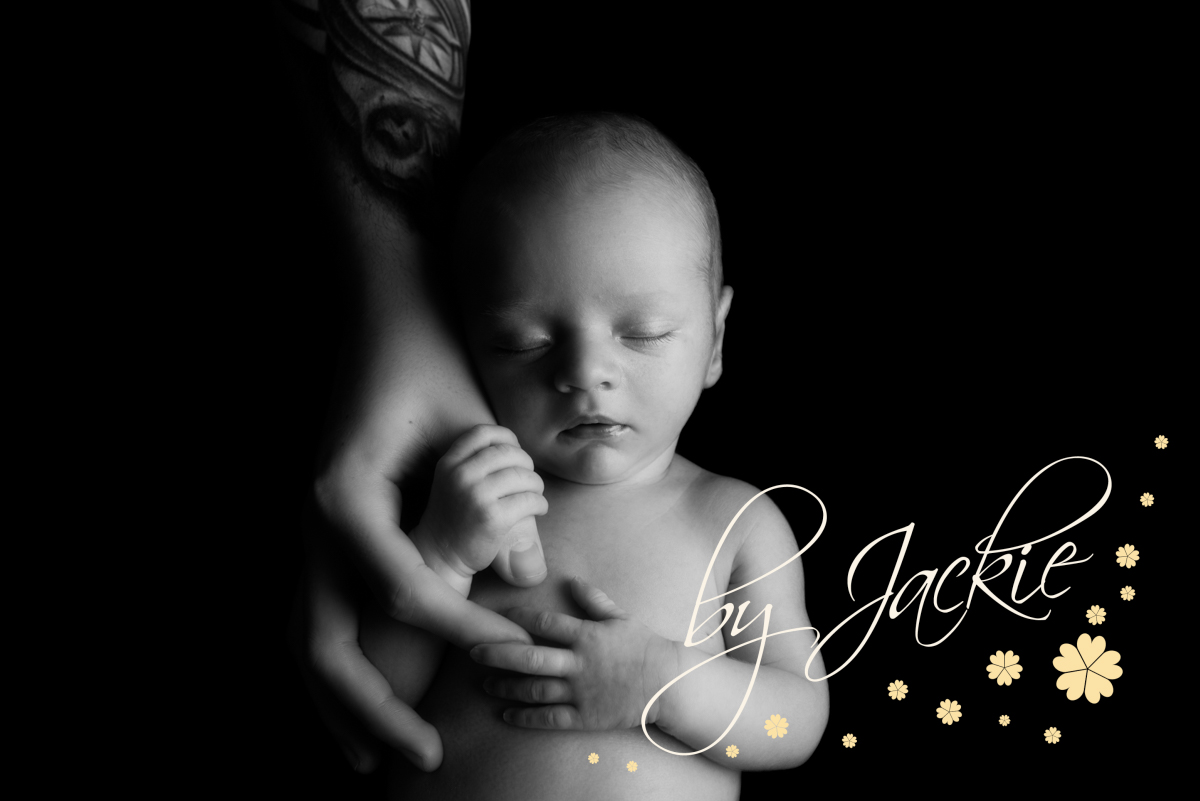 Newborn baby boy holding daddy's hand, photograph by Babies By Jackie Photography, specialist baby photographer in York, Leeds, Harrogate