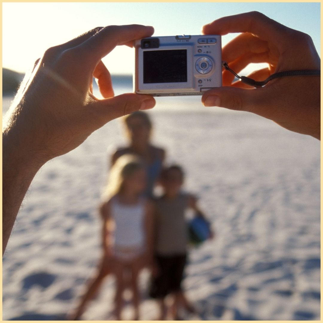 Family taking photo at the beach