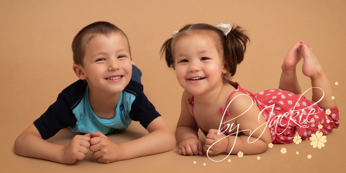 Little boy and girl laughing at family portrait photo shoot with babies By Jackie Photography in York, Leeds, Harrogate, Hull