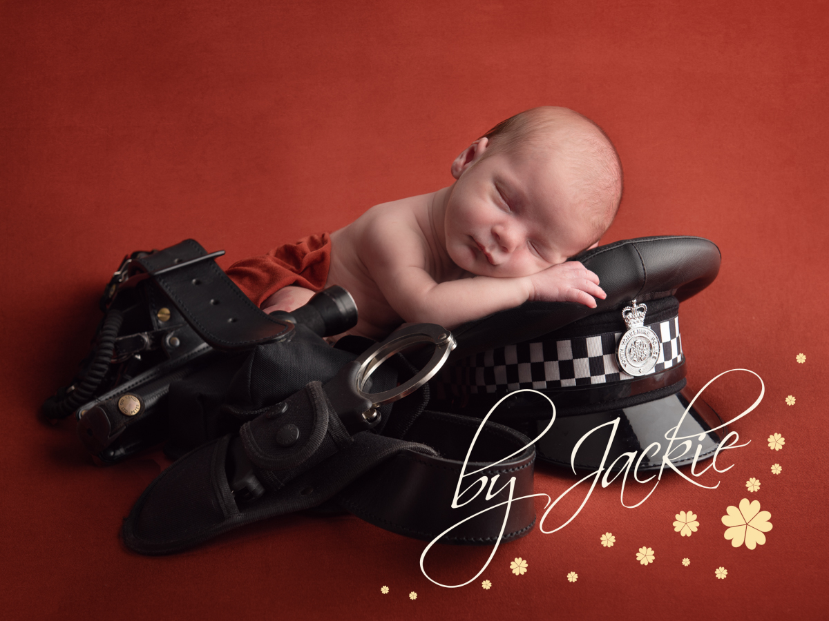 Newborn baby boy portrait with dads work gear. Copyright Babies by Jackie