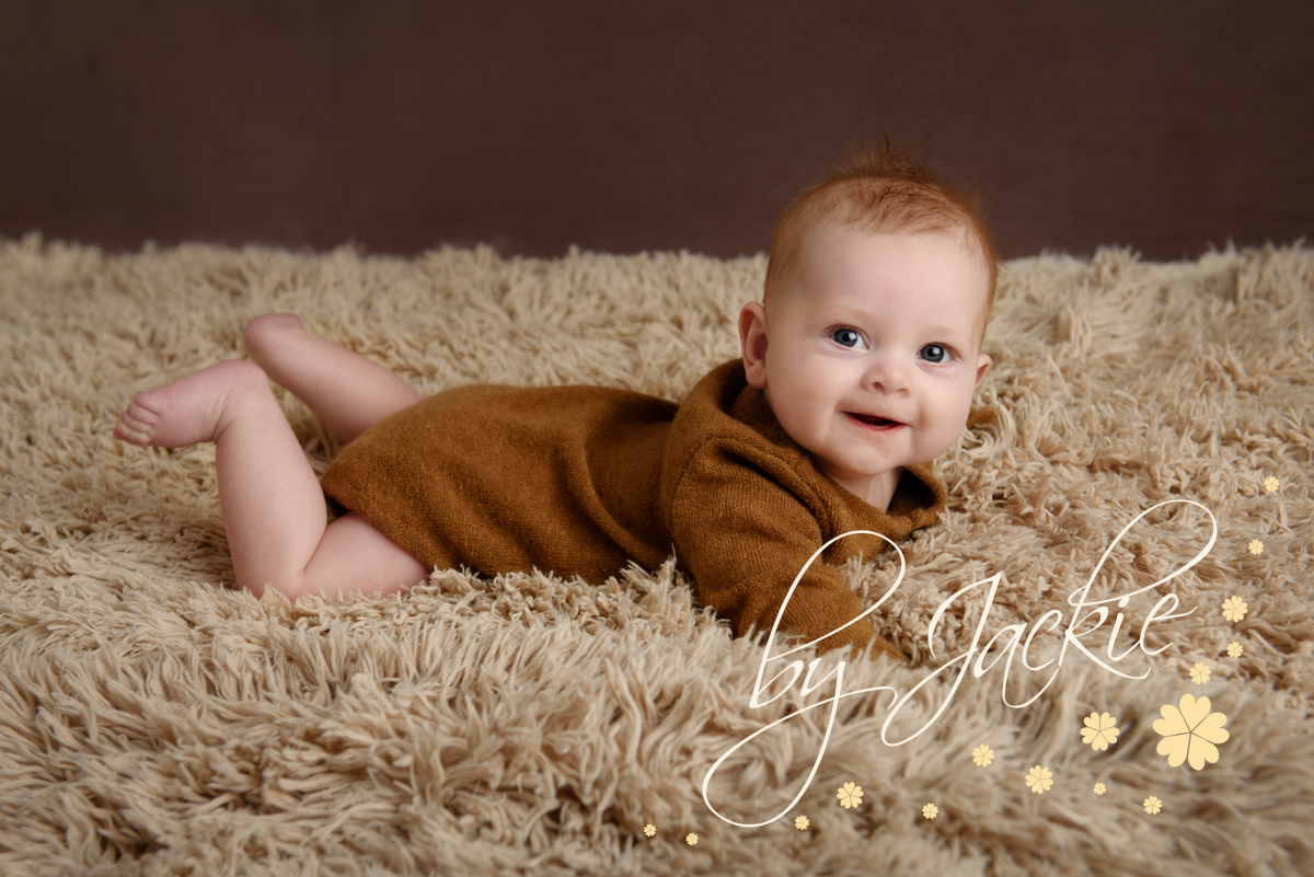 4 month old baby boy on his tummy for tummy milestone session with Babies By Jackie Photography, specialist baby and child photographer in York, Leeds, Harrogate