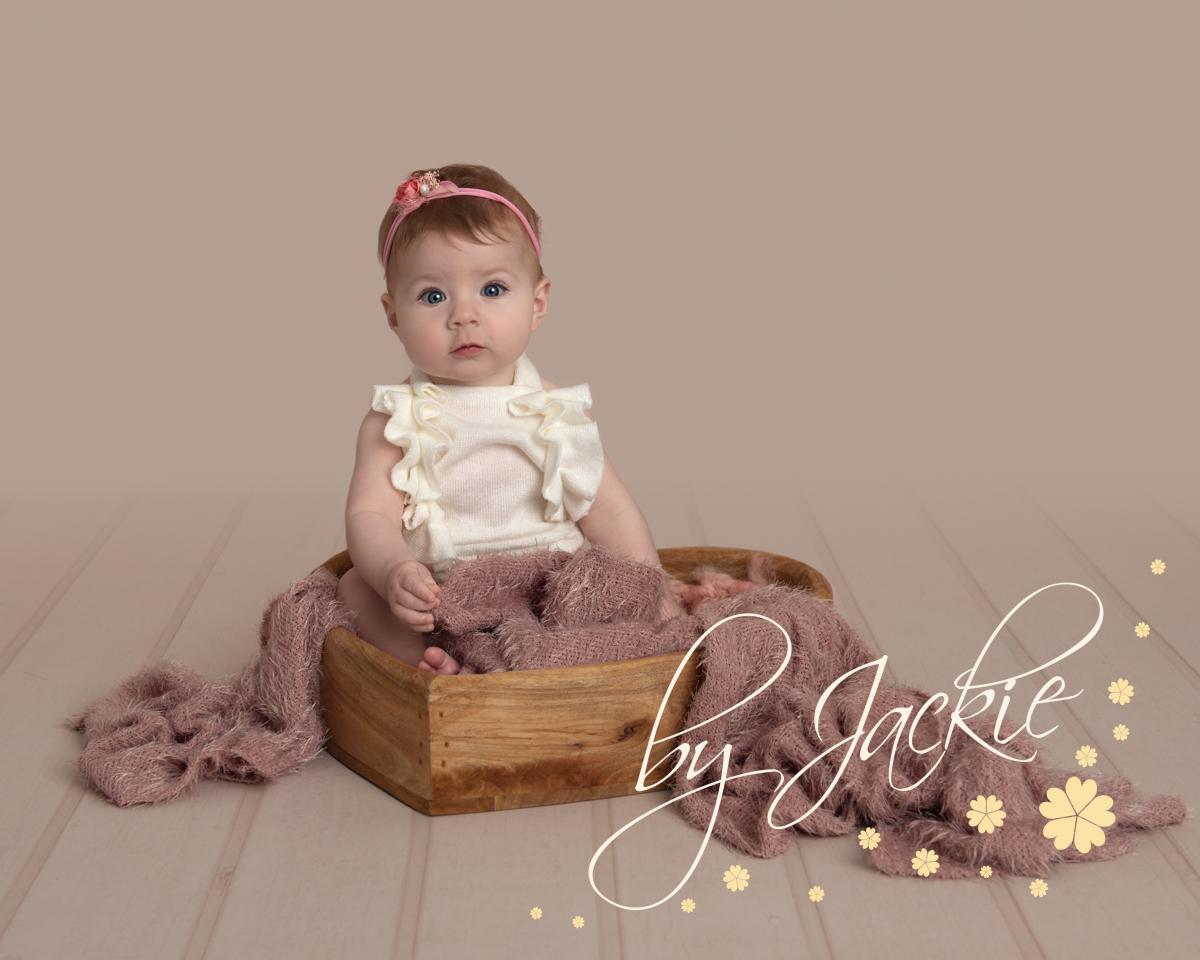 4 month baby girl sitting at her sitter session with Babies By Jackie Photography York Leeds Harrogate