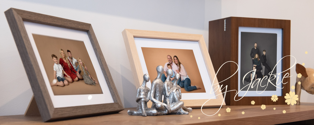 Shelf displays of family portraits by Babies by Jackie