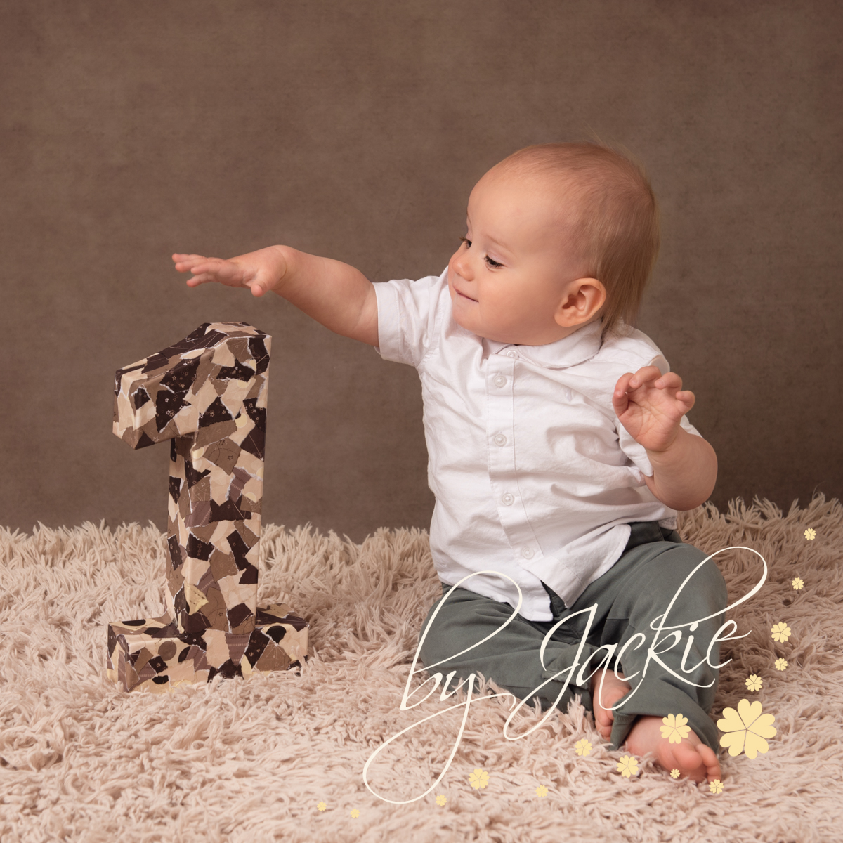 first birthday portrait of little boy with number 1