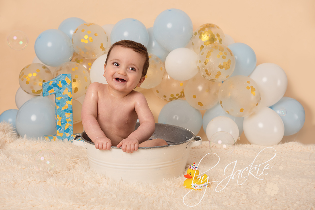 splashing good time at cake smash and splash first birthday photoshoot with babies by jackie, york, leeds, harrogate, brough, pocklington, beverley, yorkshire