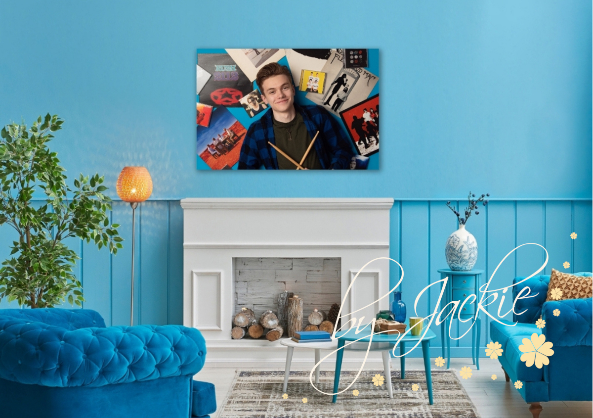 Teen portrait with album covers and drumsticks displayed in bright blue living room by Babies By Jackie Photography
