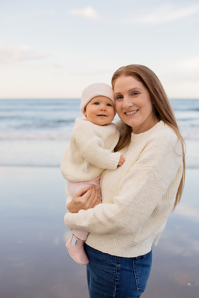 Black and white portrait of mother and daughter on beach in Mount Maunganui