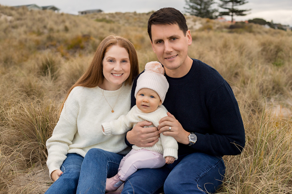 Black and white portrait of mother and daughter on beach in Mount Maunganui