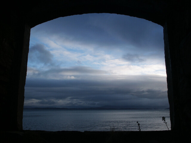 Scotland sunset on Skye through ruin, Scotland, Uk